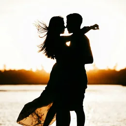 A couple embracing at sunset by the sea